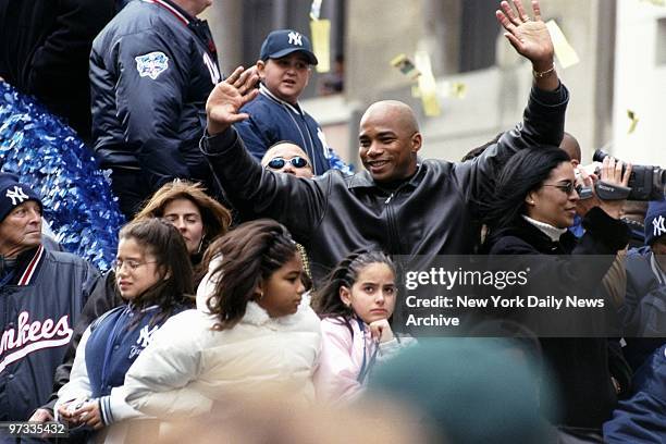 Orlando Hernandez waves to the crowd as floats carrying the World Champion New York Yankees move up Broadway through the Canyon of Heroes during a...