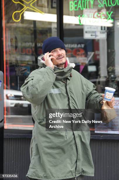 Orlando Bloom conversing with Christina Ricci on his cell phone while being filmed on Columbus Ave filming New York I Love You