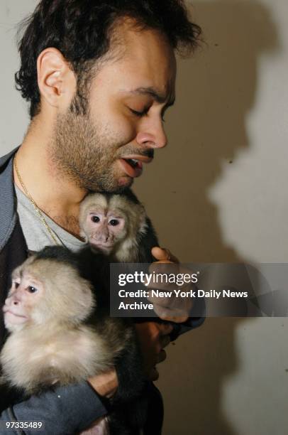 Orlando Lopez cuddles two of six monkeys removed by animal control officers from his Washington Heights studio apartment. Cops also took away a Great...