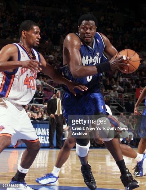 Orlando Magic's Patrick Ewing drives around New York Knicks' Kurt Thomas during action at Madison Square Garden. The Magic beat the Knicks, 108-97,...