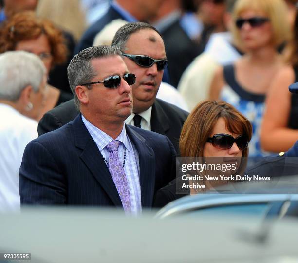 Warren Hance, father of three victims and brother of mom, comes out of the church at the funeral for Emma, Alyson and Kate Hance and Diane and Erin...