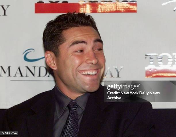 Oscar de la Hoya smiles at news conference at the All Star Cafe announcing World Boxing Welterweight Championship fight in Las Vegas between de la...