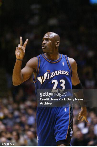 Washington Wizards' Michael Jordan gestures while on the court during a game against the New Jersey Nets at Continental Airlines Arena. Jordan scored...