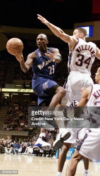 Washington Wizards' Michael Jordan passes the ball as he's guarded by New Jersey Nets' Aaron Williams during a game at Continental Airlines Arena....