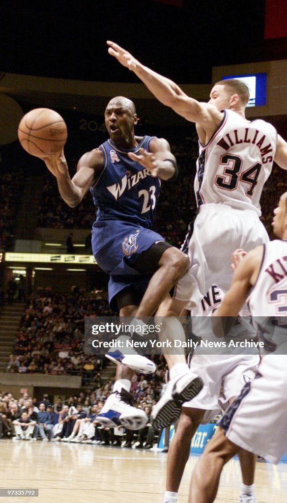 Washington Wizards' Michael Jordan passes the ball as he's g