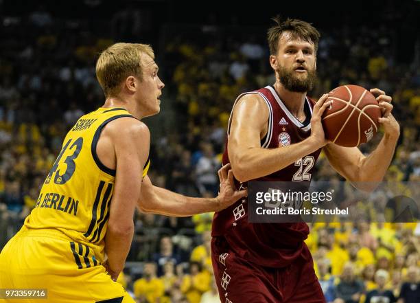 Danilo Barthel of Bayern Muenchen competes with Luke Sikma of ALBA Berlin during the fourth play-off game of the German Basketball Bundesliga finals...