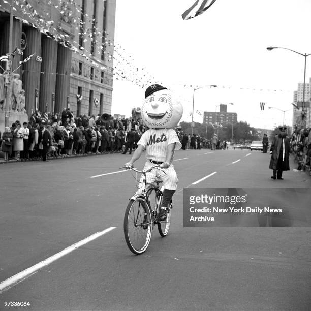 Out of his element, Mr. Met on a bicycle rides in parade on the Grand concourse celebrating the Bronx 50th Anniversary
