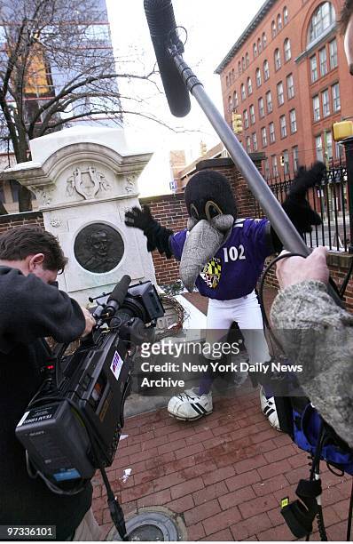 The Baltimore Raven's mascot, a "raven" named Allan, hams it up by the grave of Edgar Allan Poe at Westminster Hall on the occasion of Poe's 192nd...
