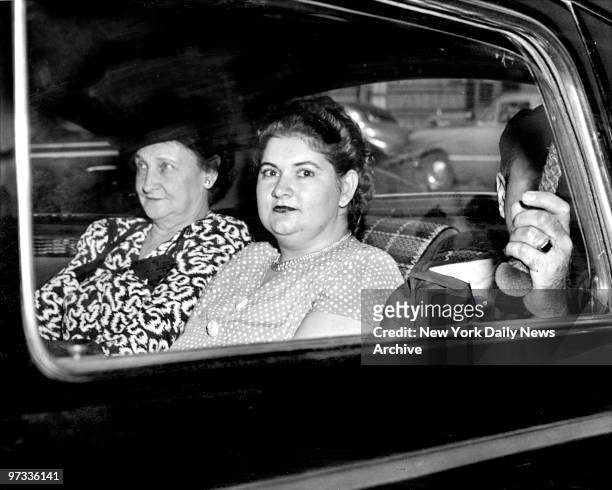 Wearing a gray silk polka dot dress and sporting a new hairdo, Martha Beck, in car leaves Bronx Courthouse for Sing Sing Prison after being sentenced...
