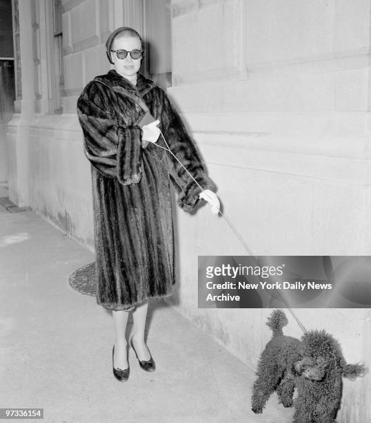 Wearing dark glasses and carrying prayer book, actress Grace Kelly walks unnoticed along Madison Ave. At 81st St. After attending early Palm Sunday...