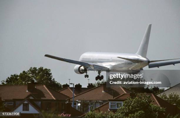 Boeing 767-300 on final-approach flying over houses.