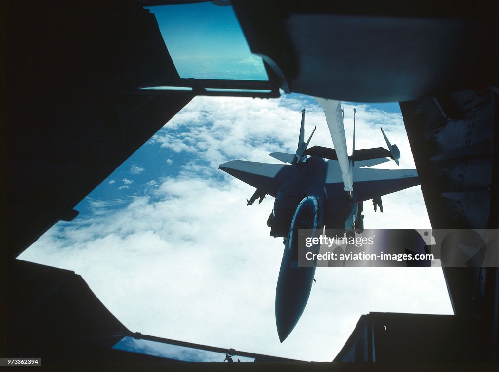 USAF Boeing F-15E Strike Eagle of 335 Sqn armed with a full load of 500 pound bombs during aerial-refuelling by a McDonnell Douglas KC-10A tanker
