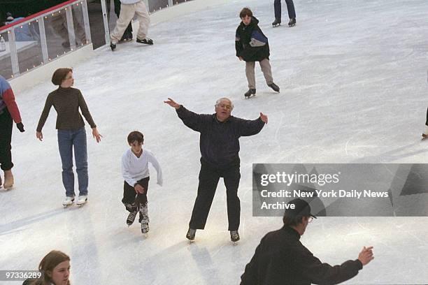 Weekend day in midtown., Skaters enjoy the ice skating rink at Rockefeller Center. Ice skating rink.