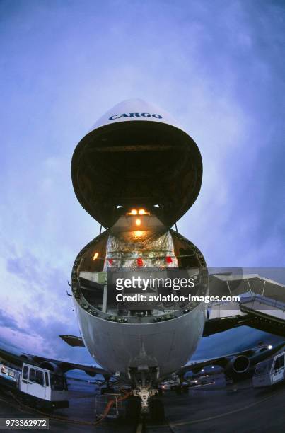 Nose cargo loading door of a Boeing 747-200F opening at dawn.