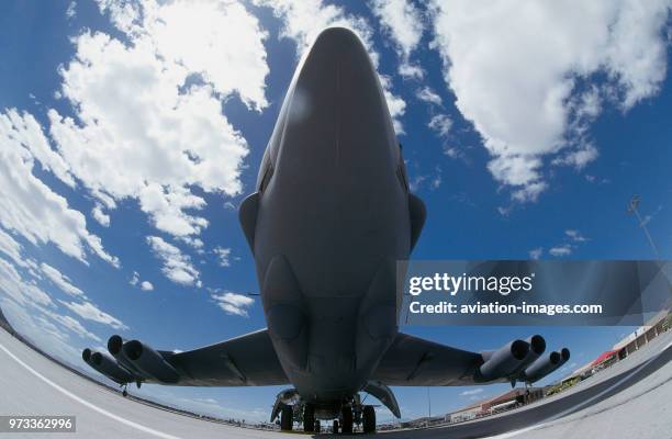 Nose of a USAF Boeing B-52 Stratofortress parked with clouds.