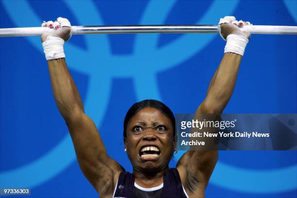 Weightlifter Blessed Udoh of Nigeria competes in the 48-kilogram class competition at the Nikaia Olympic Weightlifting Hall during the 2004 Summer...