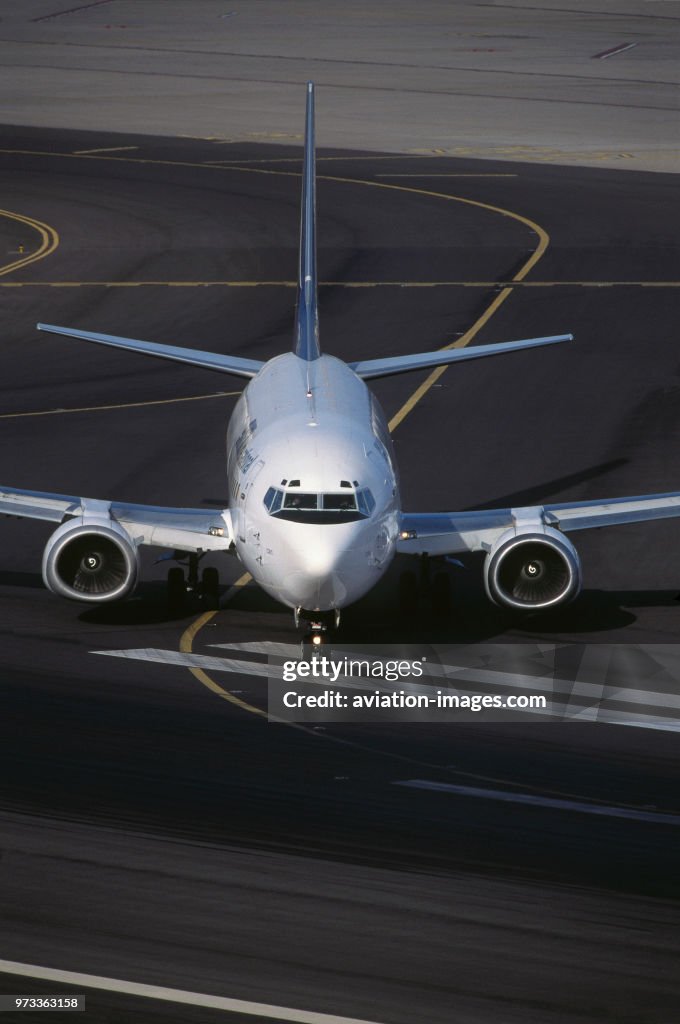 SATA International Boeing 737-300 taxiing from the taxiway onto the active runway