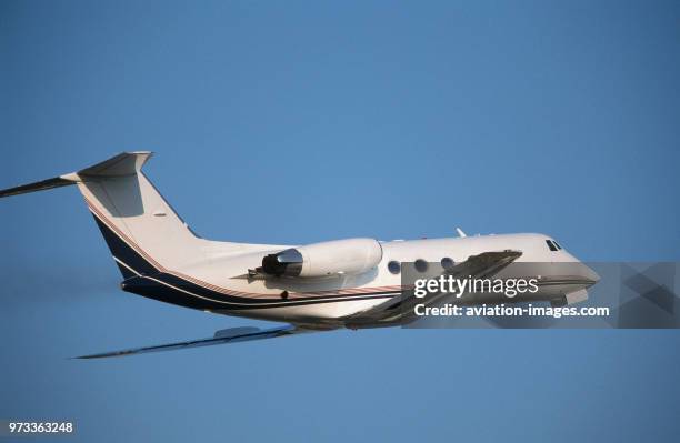 Grumman G-1159 Gulfstream 2 / II climbing out after take-off with black smoke from the engines.