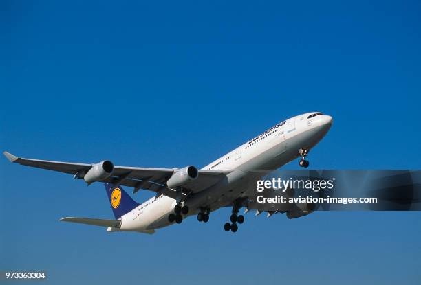 Lufthansa Airbus A340-200 climbing out after take-off with undercarriage retracting.