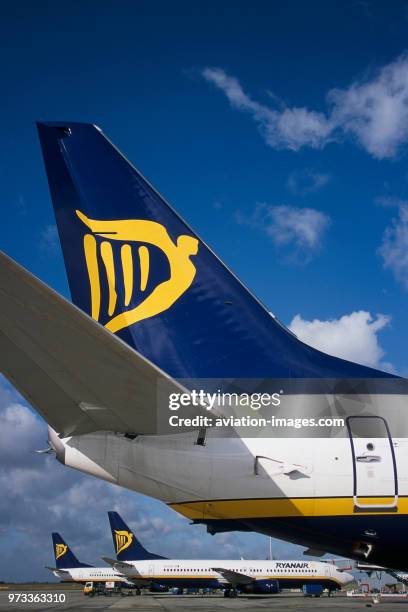 Tail-fins with logos of Ryanair Boeing 737s parked at the terminal.