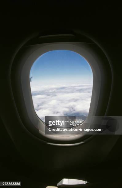 View through airliner cabin window of an Air Portugal Airbus A321 of clouds over the eastern Atlantic FNC-LHR.