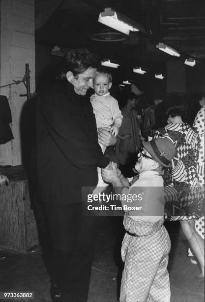 American singer-songwriter Johnny Cash shakes hands with a clown at the Ringling Brothers And Barnum & Bailey Circus in Madison Square, New York, May...
