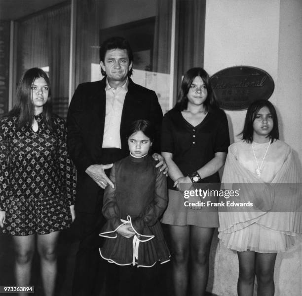 American singer-songwriter Johnny Cash and his four daughters from his first marriage on heir way to a Catholic Mass at the Church of St Anastasia in...