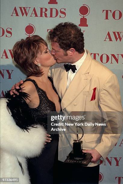 Owen Teale, winner Best Featured Actor for " A Doll's House," kissing presenter Raquel Welch during Tony Awards at Radio City Music Hall.