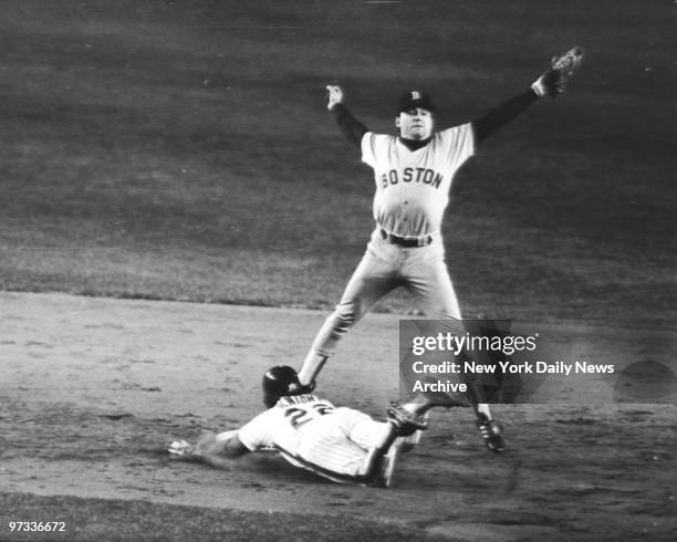 New York Mets' Ray Knight is safe at 2nd base on a play after a base hit bunt by Mookie Wilson, as Boston Red Sox shortstop Spike Owen takes throw...