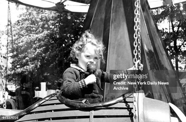 Palisades Amusement Park in Fort Lee, N.J. Fortified with an apple on a stick, this aviatrix is set to take off in a kiddieland airplane