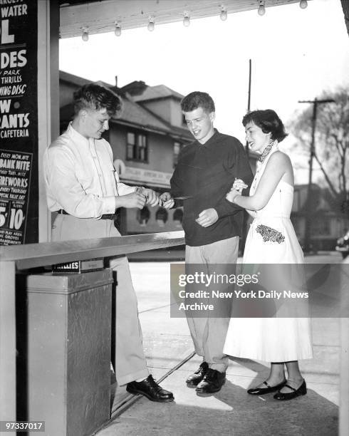Palisades Amusement Park, Johnny Rinaldi, originator of Date with a Dollar idea, takes tickets from customers. On any week day, a teenage boy may...