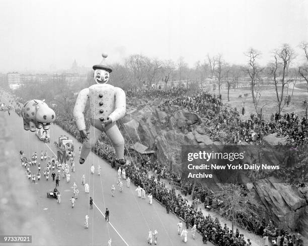 With a dopey clown and the kind of hippo you see only in a hangover, Macy's annual Thanksgiving Day parade trundles down Central Park West.