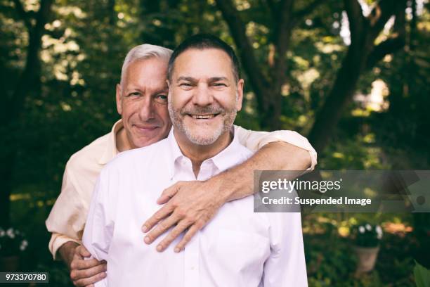 portrait of a loving middle-aged gay couple - casal gay imagens e fotografias de stock