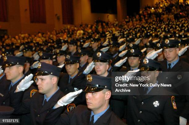 White gloves are raised to caps in unison during Fire Department graduation ceremonies at Brooklyn College, where 286 probationary firefighters...