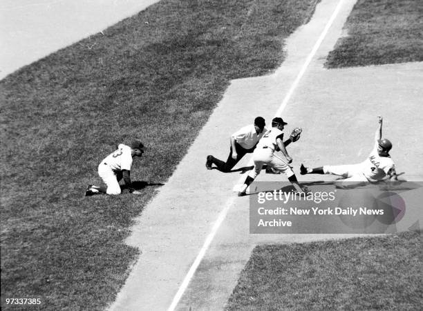 New York Mets' Ron Swoboda goes barreling into third but Giant Jim Davenport is waiting for him. Ump Billy Williams called Swoboda out. Giants won...