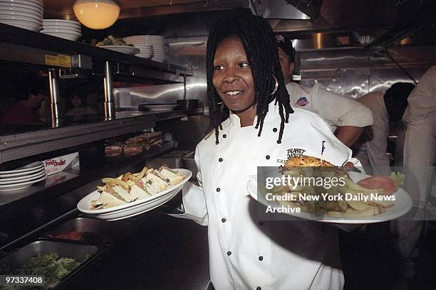 Whoopi Goldberg helps out in the kitchen at Planet Hollywood for Whoopi Day where she met fans and signed autographs.