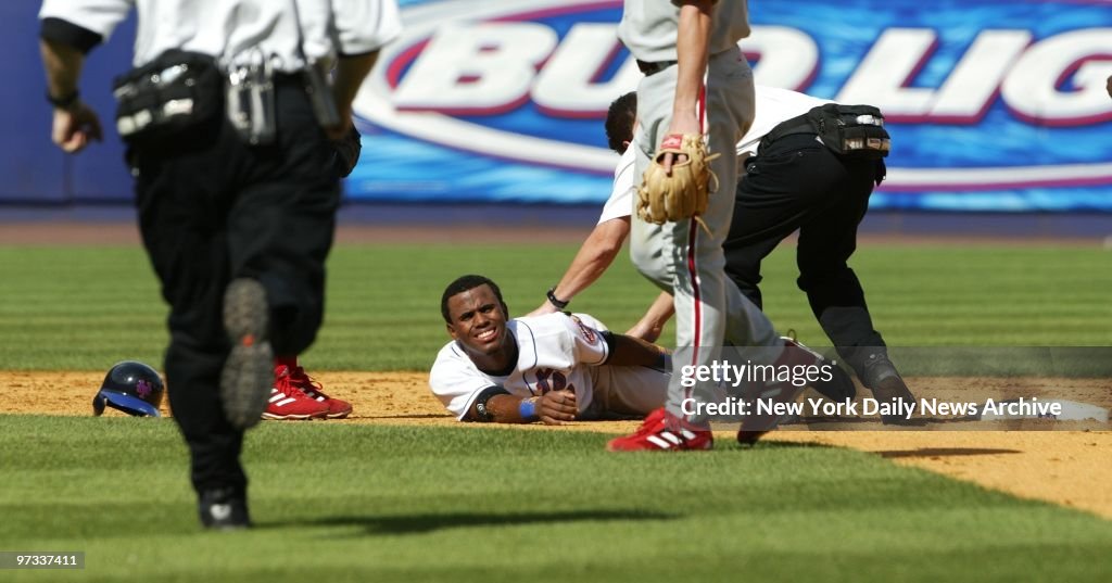 New York Mets' rookie Jose Reyes grimaces in pain after spra