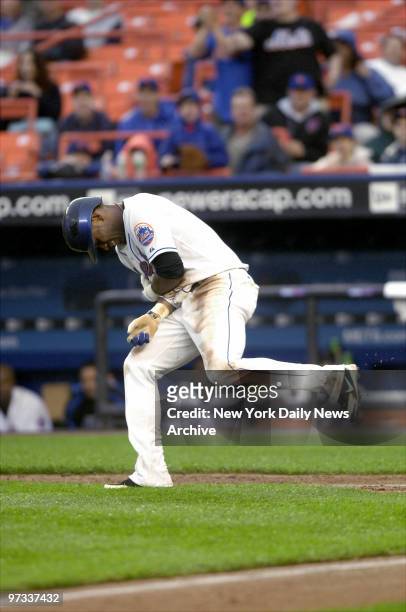 New York Mets' shortstop Jose Reyes winces in pain after he was hit with a pitch by San Francisco Giants' starter Matt Cain during the fifth inning...