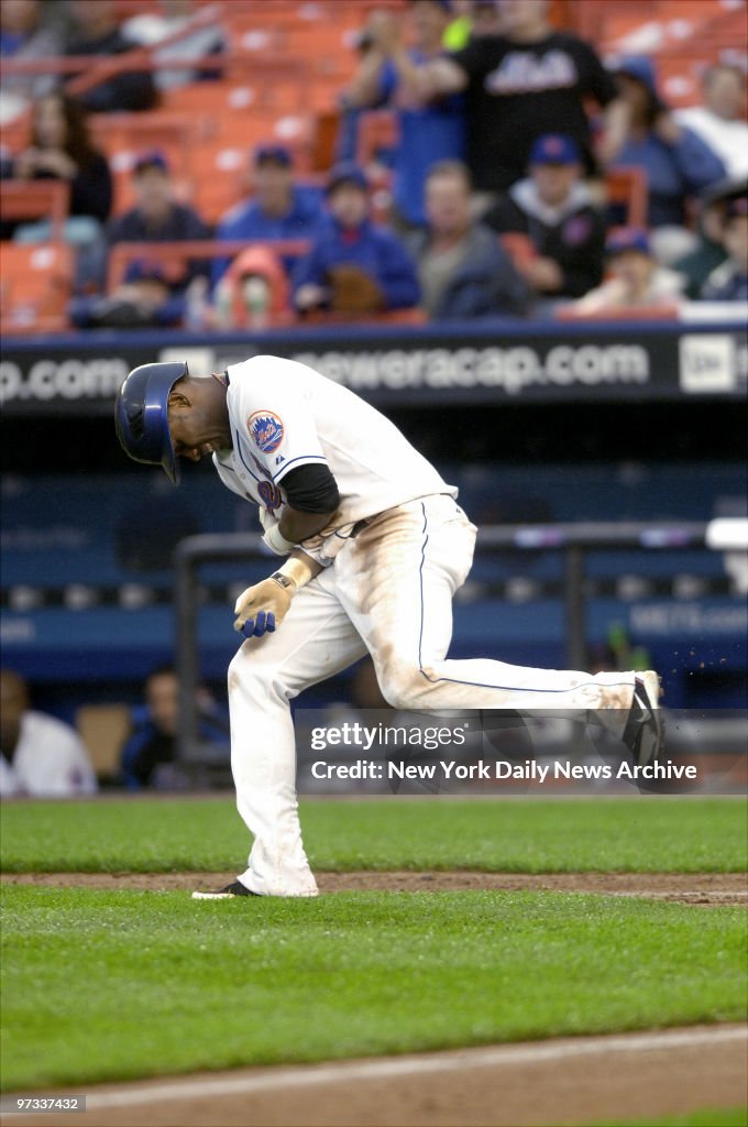 New York Mets' shortstop Jose Reyes winces in pain after he