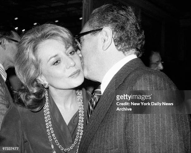 Who's that planting that chaste kiss on the cheek of Barbara Walters? Could it be that old ladies' man, Henry Kissinger? Why, it could be and is....