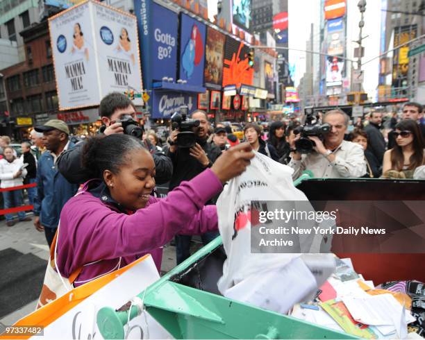 Donna Roberts of Corona, Queens throws away 401K statements, old bank records and other ghosts of bad times in 2008 in Times Square Sunday afternoon...