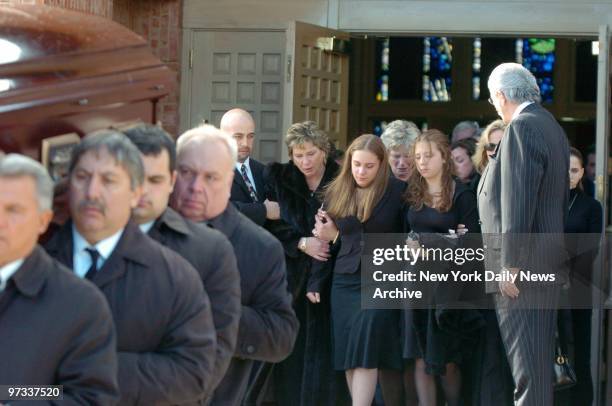 Widow Laura Moretti and 16-year-old daughter Megan follow the coffin of Dr. Anthony Moretti from Holy Rosary Catholic Church in Dongin Hills, Staten...