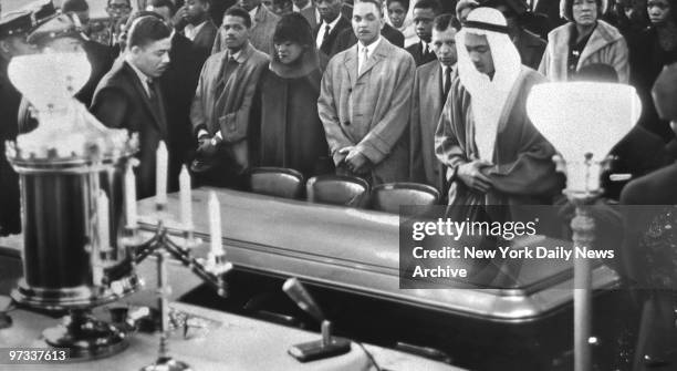 Wife of Malcolm X, Mrs. Betty Shabazz, stands in front row during Muslim rites.