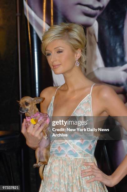 Paris Hilton holds her pet Chihuahua, Tinkerbell, as she unveils the Paris Hilton Limited Edition Watch Collection at the Tourneau Time Machine at...