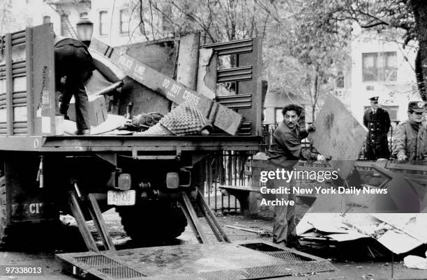 Parks department workers remove shelters of homeless people who were living in Tompkins Square Park.