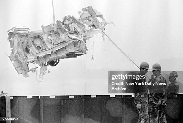 Part of the fuselage of TWA Flight 800 is loaded onto a truck at the Coast Guard station in Shinnecock, L.I.