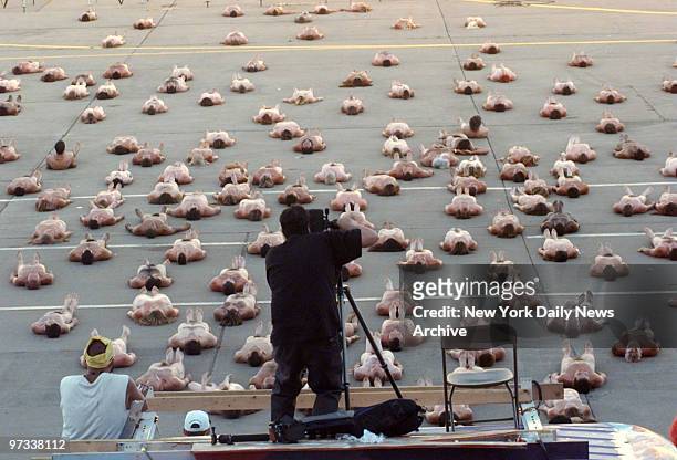 Participants have nothing to hide as photographer Spencer Tunick, who specializes in nude group photos, takes their picture at Woodstock '99 in Rome,...