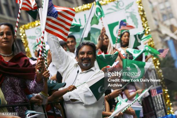 Participants show their pride as they ride a float along Madison Ave. During the Pakistan Independence Day Parade.
