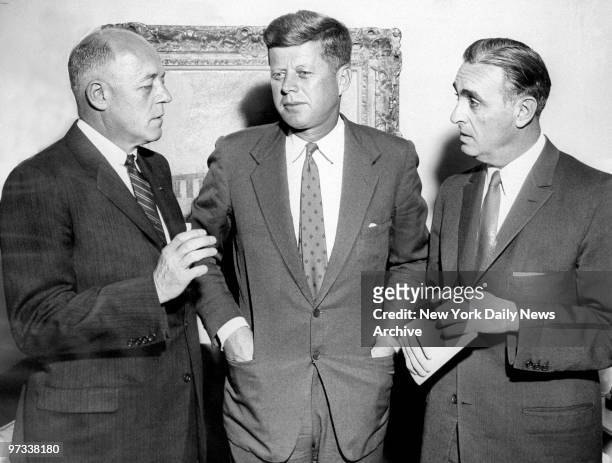 Dr. Frederick Hovde discusses report on federal aid to education with President-elect John F. Kennedy and Governor Ribicoff at the Carlyle Hotel.