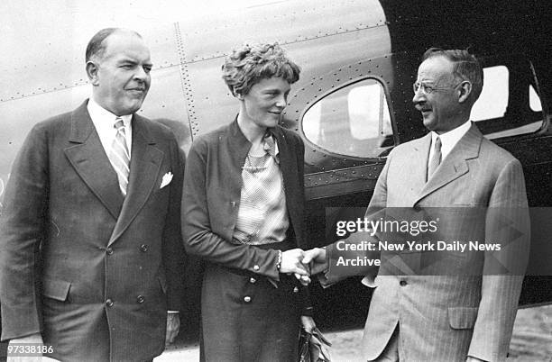 Dr. Gilbert Grosvenor, President of the National Geographic Society, shakes hands with Amelia Earhart at Hoover Field.